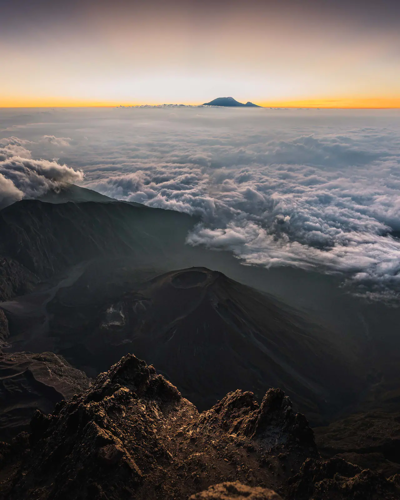 Mountain peaks rising through a cloud sea