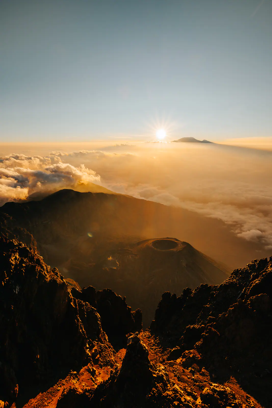 Mountain peaks rising through a cloud sea