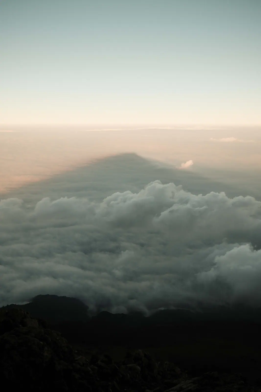 Mountain peaks rising through a cloud sea