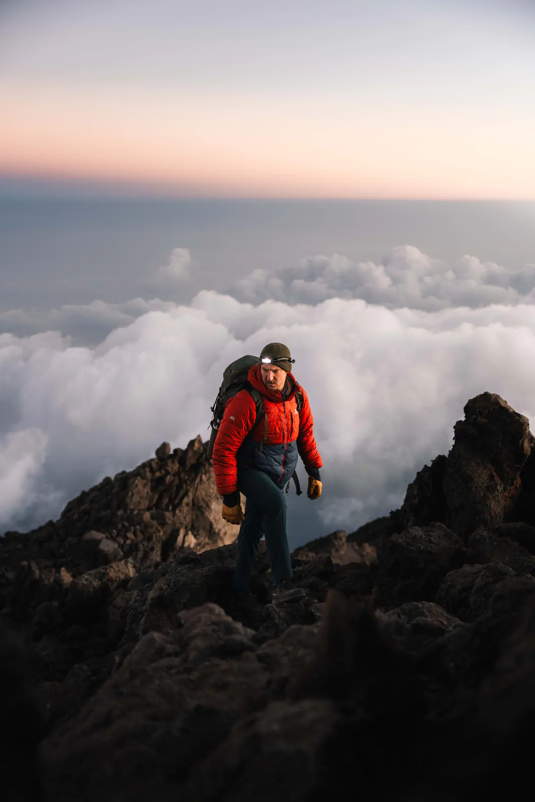 A trekker high on the mountain above a sea of clouds