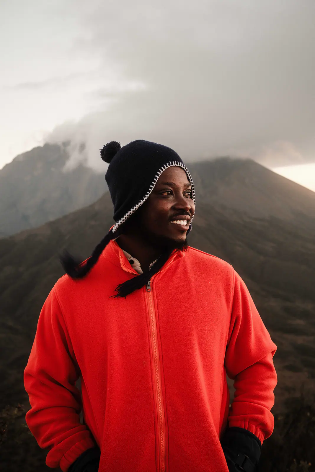 A mountain guide in a red fleece smiling to camera