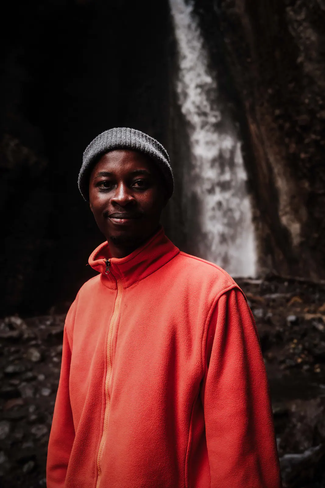 A mountain guide in a red fleece smiling to camera