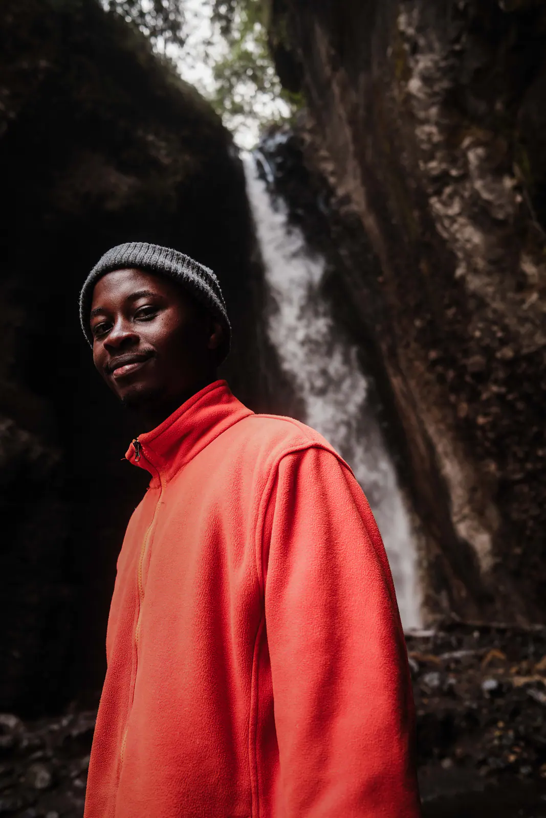A mountain guide in a red fleece smiling to camera
