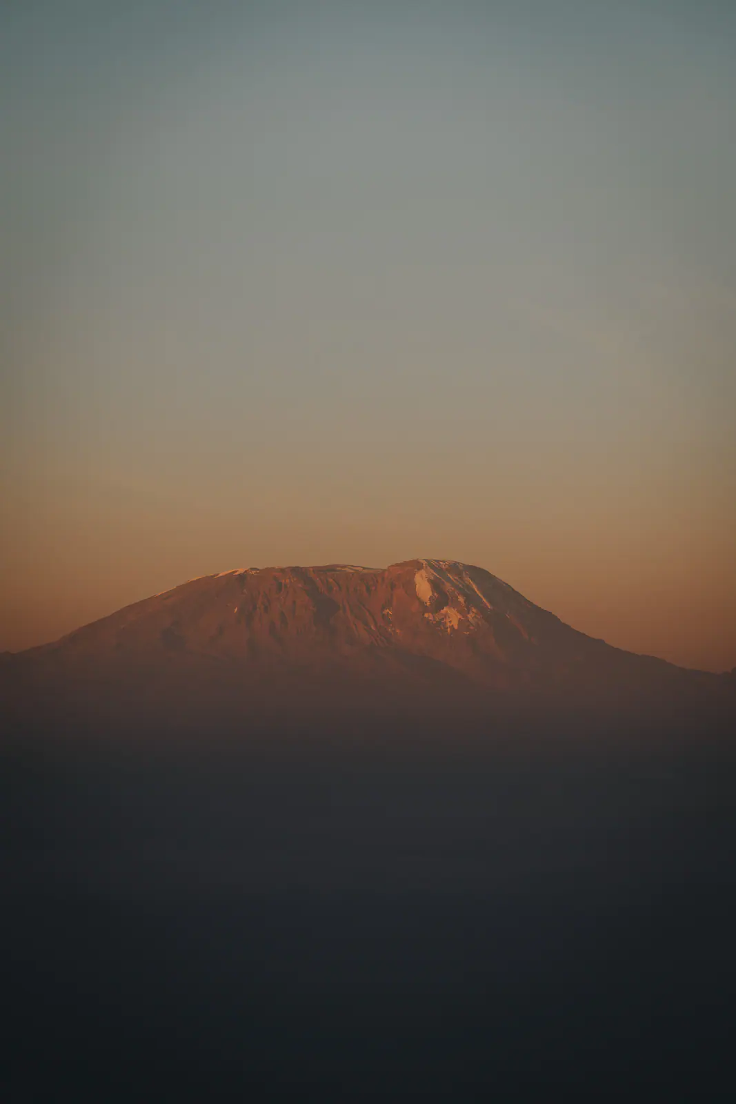 Kilimanjaro’s silhouette rising above the haze