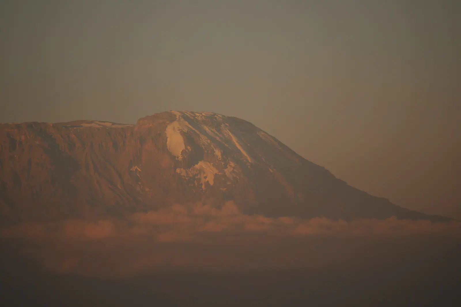 Kilimanjaro’s silhouette rising above the haze