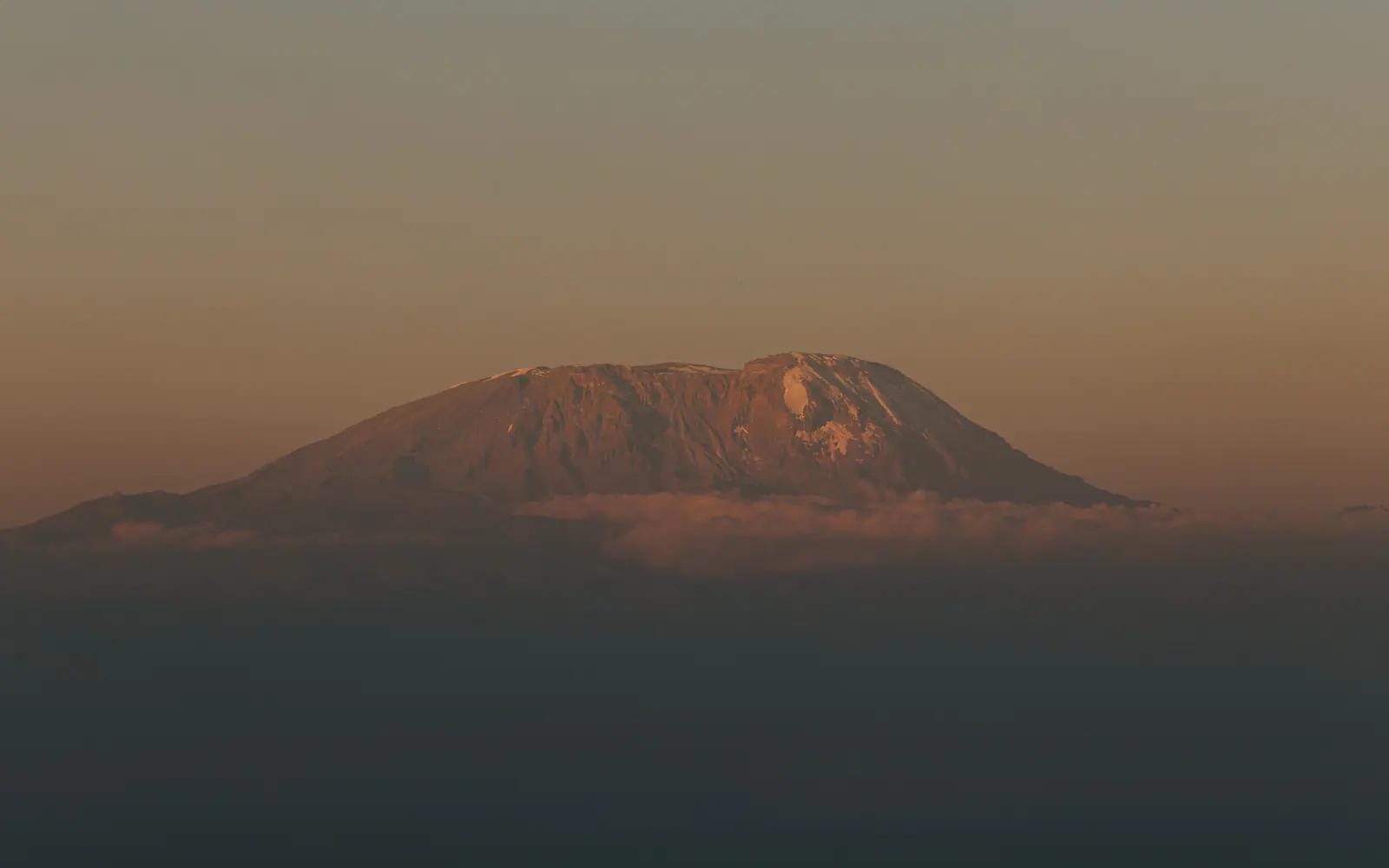 Kilimanjaro’s silhouette rising above the haze