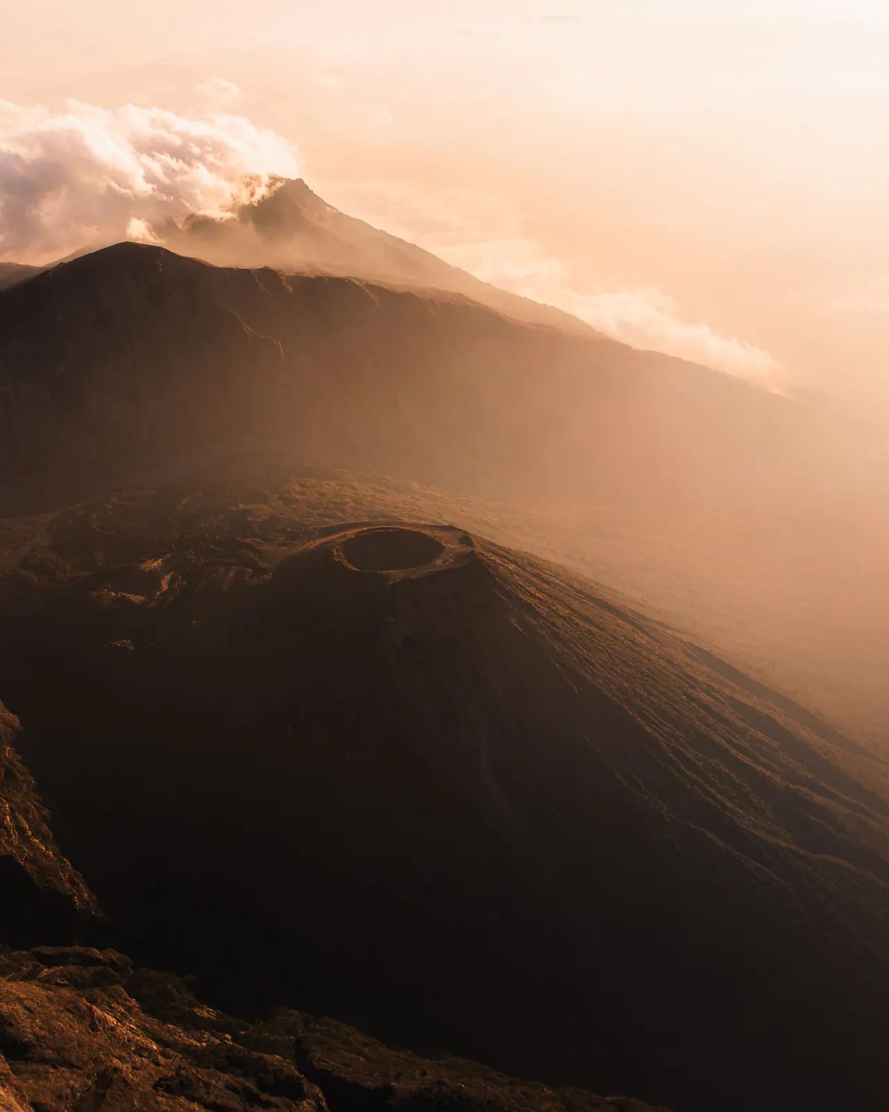A lone trekker on a jagged ridge at sunrise
