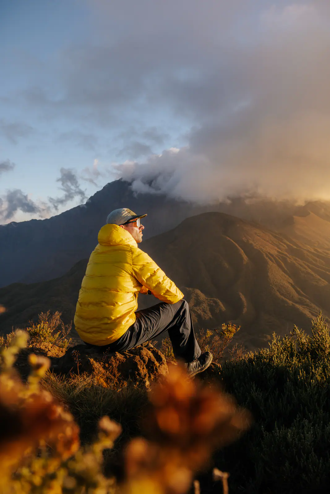 A trekker resting on a mountain ridge at sunrise
